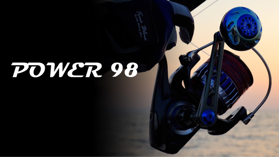LIVRE POWER 98 power handle mounted on a large spinning reel at sunset